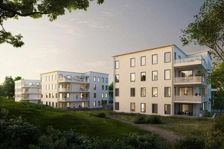 Bild på nybyggda och moderna flerbostadshus omgiven av grönska